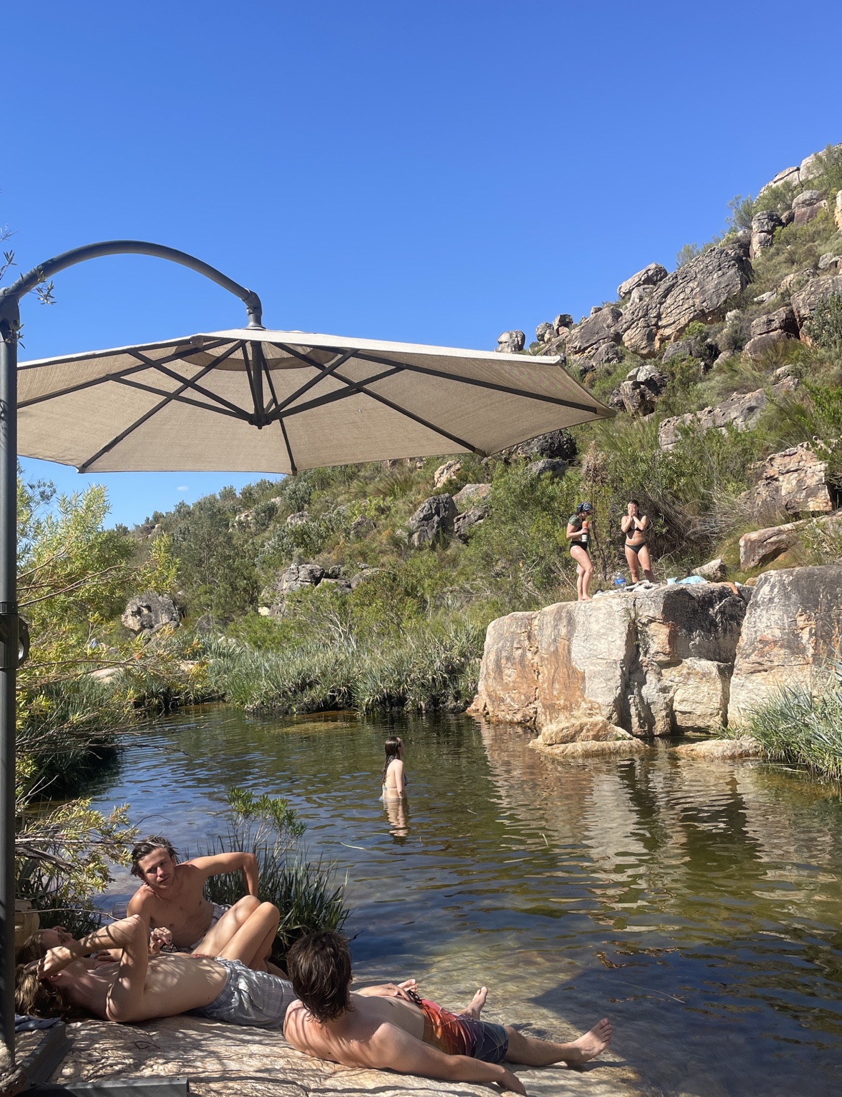 Guests swimming and relaxing at a rock pool in the Cederberg